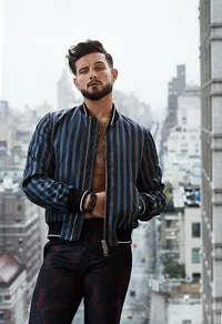 Nico Tortorella in a stylish, urban portrait, highlighting a confident pose and edgy fashion, photographed by Ylva Erevall.
