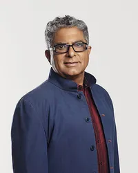 Dr. Deepak Chopra in a composed portrait, emphasizing his calm demeanor and insightful presence, captured by Ylva Erevall.