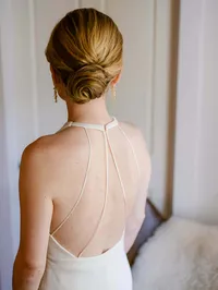 bride from the back with a beautiful open back gown and a sleek bun