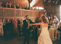 bride and groom dancing in a warm cozy space