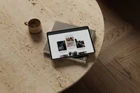 iPad on a coffee table showing an editorial showit website template