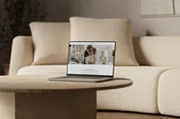 Laptop on a table with a sofa in the background, showing an elegant Showit website design