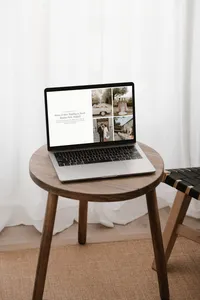 Laptop on a chair showing an elegant showit website template