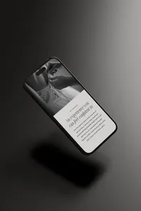 iPhone with a dark background showing an editorial showit website template