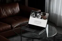 Laptop in a dark setting showing a testimonial section of an editorial showit website template