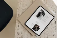 iPad on a coffee table showing an editorial showit template for photographers