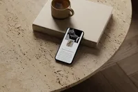 iPhone on a coffee table showing an editorial showit template for photographers