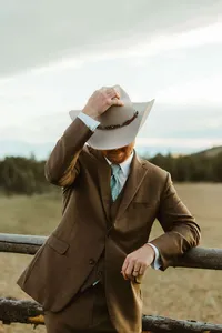 Western wedding groom poses