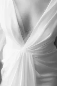 Macro film shot of intricate wedding dress lace and fabric, highlighting luxury bridal fashion and craftsmanship.