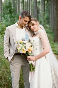 Newlyweds are posing after their ceremony in the woods captured on analog