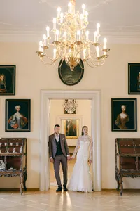 Elegant destination wedding couple posing in the grand halls of Lobkowicz Palace, Prague, in a fine art storytelling style.