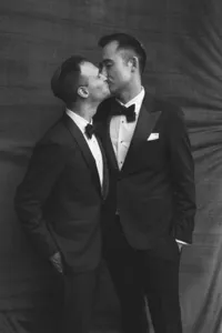 Two grooms kissing during their wedding day in San Sebastián