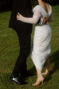 Poetic and artsy shot of newlyweds dancing alone in a garden, emphasizing movement and a dreamy cinematic atmosphere in Tuscany, Italy