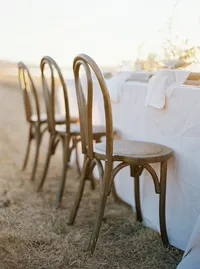 Minimalist outdoor wedding seating and table setup with natural textures