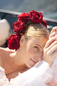 Close-up of a bride with deep red roses tucked into her hair