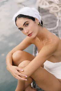 Close portrait of model with white headpiece and minimal styling photographed at Lake Como