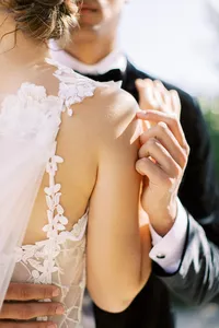 Close-up portrait of bride and groom embracing during Sunstone Winery wedding.