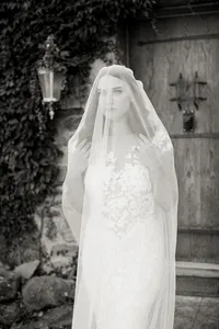 Elegant black and white bridal portrait with flowing veil in front of Italian-style architecture during a romantic winery wedding in Lake Oswego Oregon