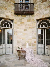 Wedding cake with oversized silk linen and florals displayed at Sunstone Winery reception.