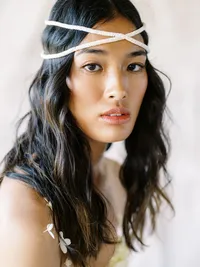 Editorial bridal portrait with modern headpiece and natural makeup