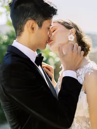 Bride and groom kissing during romantic Sunstone Winery vineyard wedding in Santa Ynez Valley.