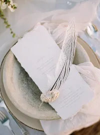 Handmade paper and feather detail on plate for editorial wedding styling