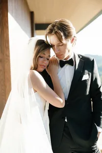 Bride leaning into groom’s shoulder in a quiet moment after first look.