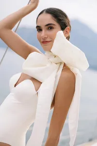 Model wearing sculptural white bow piece during Lake Como bridal fashion editorial