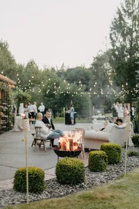 Guests enjoying outdoor lounge and fire feature during evening reception at private estate wedding in Vancouver, Washington.