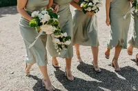 Bridesmaids in sage gowns walking together at private estate wedding in the Pacific Northwest.