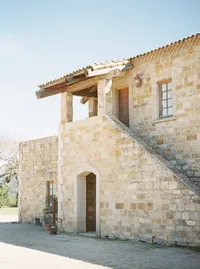 Sunstone Winery stone villa architecture surrounded by vineyards in Santa Ynez Valley.