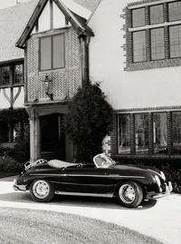 Black-and-white photo of a classic convertible parked outside the estate, a vintage transportation detail from a Santa Barbara wedding editorial by Yuliya Supin Design