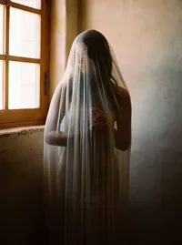Bride wearing veil inside Sunstone Winery stone villa during wedding morning