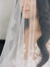 Close-up portrait of the bride with veil softly covering her face during her wedding preparations before the Lake Oswego Oregon winery wedding.