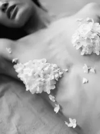 Close-up of bridal body detail with floral appliqué in editorial styling