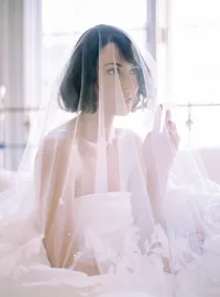 Close-up of tulle veil layered over a lace wedding gown, a delicate texture detail from a Santa Barbara wedding editorial by Yuliya Supin Design