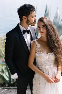 Destination wedding portrait of american couple overlooking open water