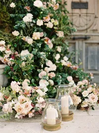 Close-up of ceremony flowers and hand-blown glass candle holders at Sunstone Winery wedding ceremony.