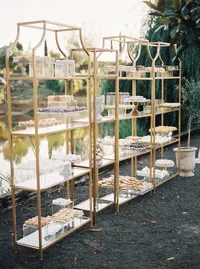 Dessert table display overlooking the lake at an Italian-inspired winery estate during a romantic Lake Oswego Oregon wedding reception.