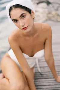 Close portrait of model with white headpiece and minimal styling photographed at Lake Como