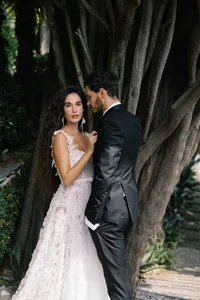 Couple embracing in terraced gardens at Hotel Villa Cipressi