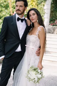 Couple embracing in terraced gardens at Hotel Villa Cipressi