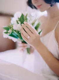 Soft-focus detail of the bride's hand holding her bouquet, an intimate moment from a Santa Barbara wedding editorial by Yuliya Supin Design