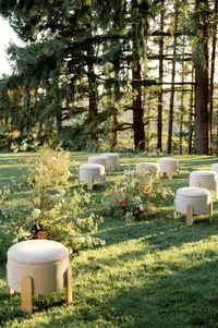 Side angle of ceremony with sunset light falling over vineyard trees.