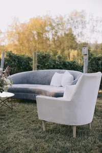 Dusty blue velvet couch and lounge chairs styled for an elegant outdoor reception lounge at a Lake Oswego Oregon winery wedding.