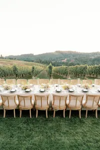 Bird’s-eye view of single reception place setting with layered textures and floral accents.