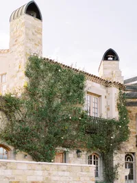 Sunstone Winery stone architecture covered with climbing jasmine flowers in Santa Ynez Valley California.
