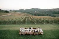 Extended reception table styled in organic luxury design under warm Oregon sunset light.