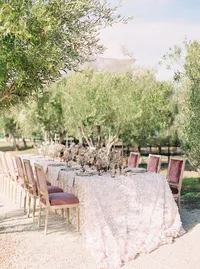 Elegant vineyard reception table styled with silk linen and garden roses at Sunstone Winery.