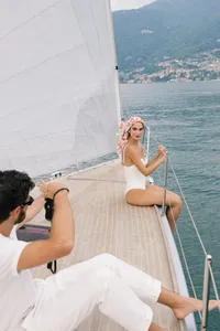 Bride seated on sailboat deck during Lake Como destination wedding